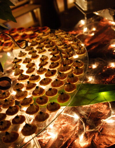 Bite-sized tartlets arranged on an illuminated glass tray