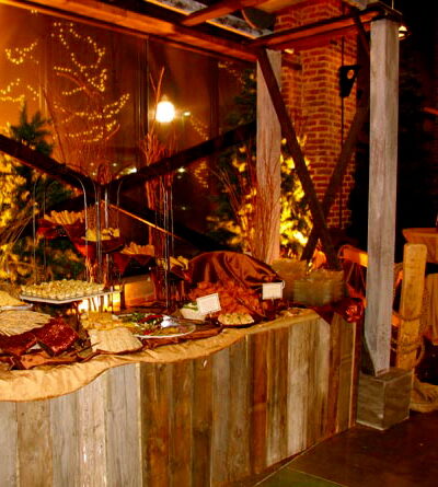 Wood-paneled buffet station with appetizer platters and a twinkle-light backdrop