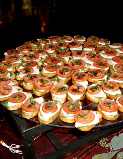 Tomato, mozzarella, and basil crostini arranged on a serving tray