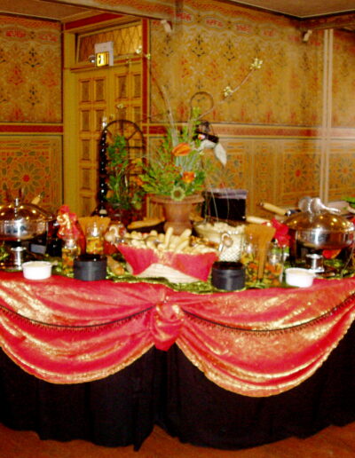Bread-and-buffet display with red-and-gold draping in an ornate banquet room