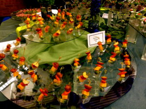 Roasted vegetable skewers arranged in individual clear cups